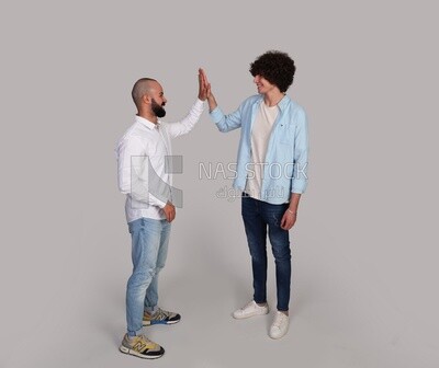 two friends shaking hands happily