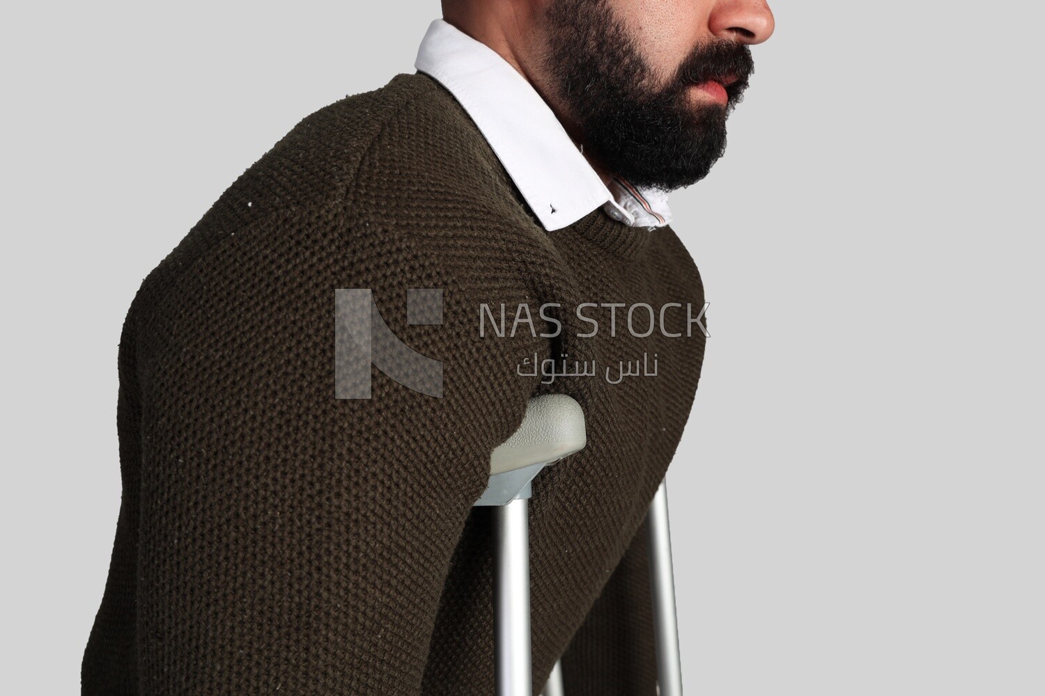 young man leaning on a crutch