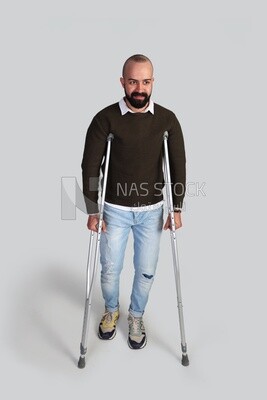 young man leaning on crutches, Front view