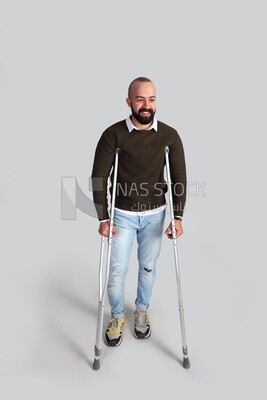 young man leaning on crutches