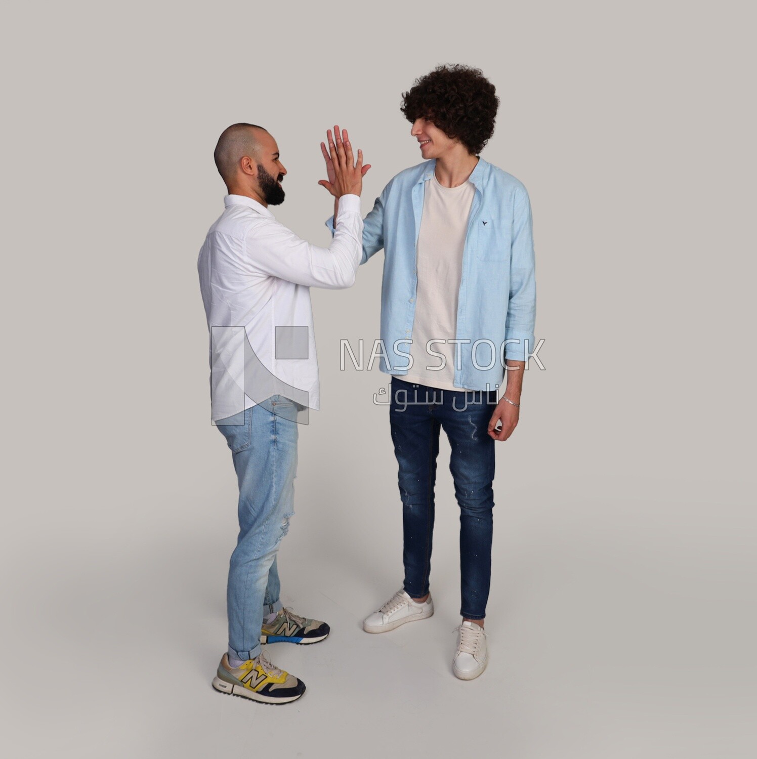 two friends shaking hands happily