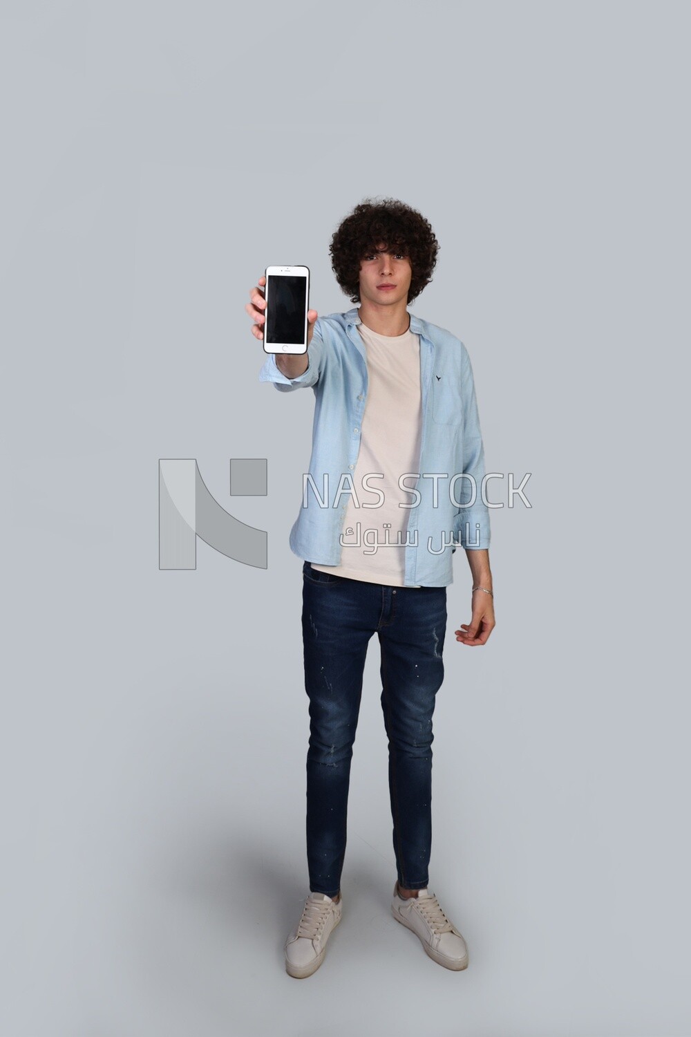 handsome young man pointing his phone at the camera