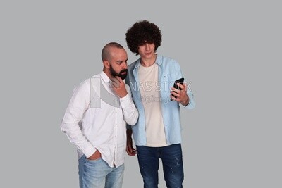two friends looking at a selfie they took together
