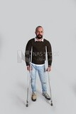 young man leaning on crutches