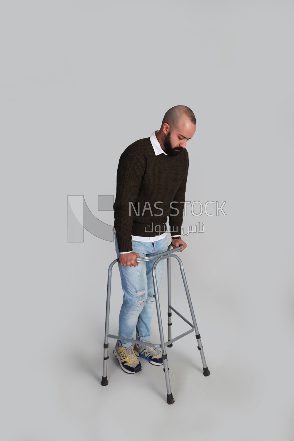Young man trying to walk with a walker