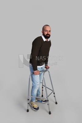 Young man trying to walk with a walker