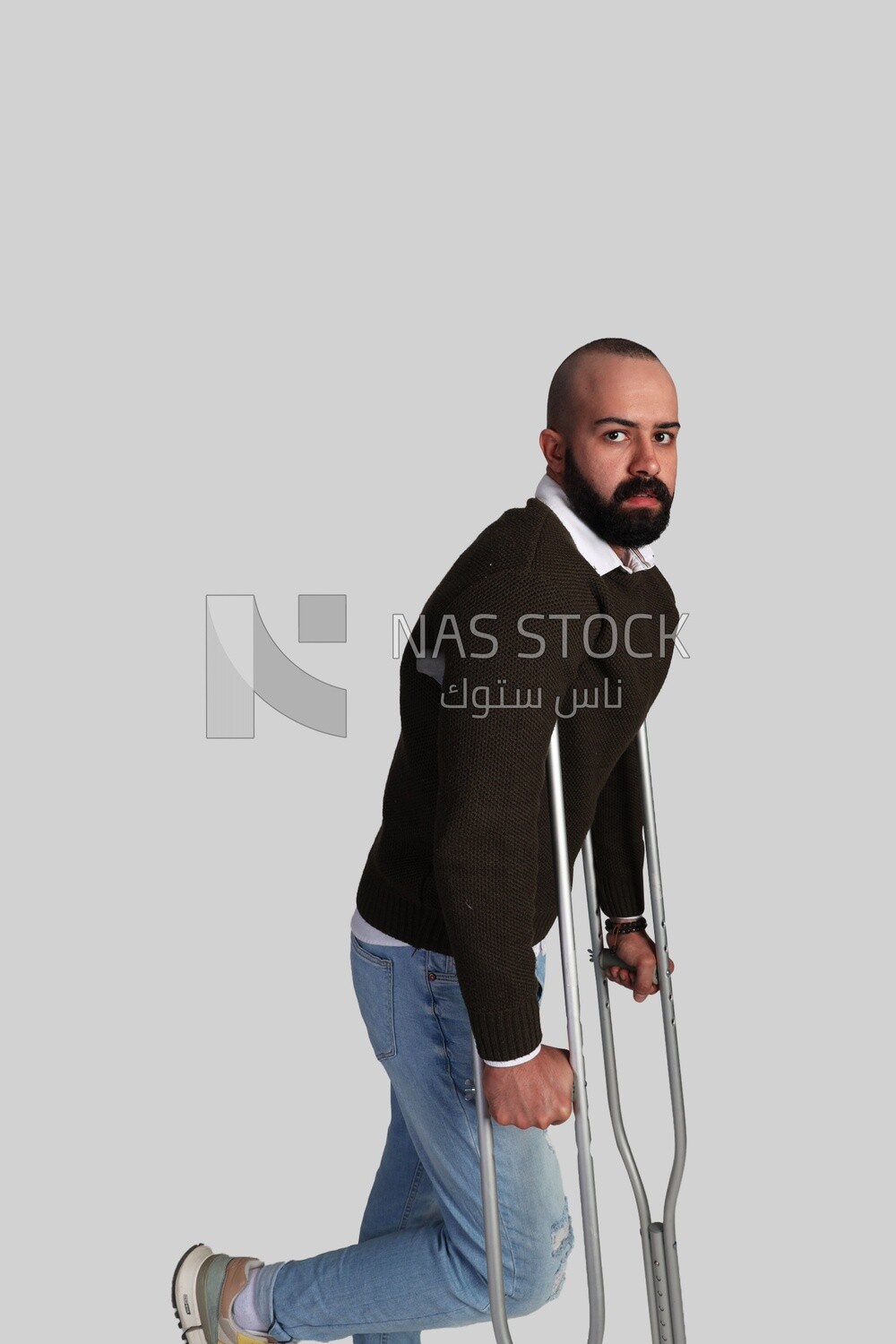 young man leaning on a crutch