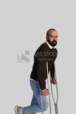 young man leaning on a crutch