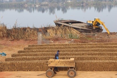 Worker at a brick factory around a lake in Egypt