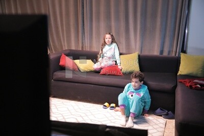 a brother and a sister playing in the living room