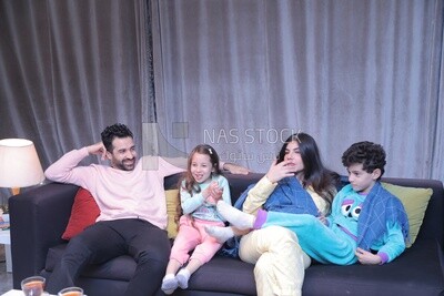 a family of four watching television