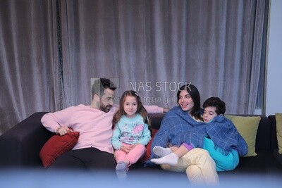 a family of four watching television
