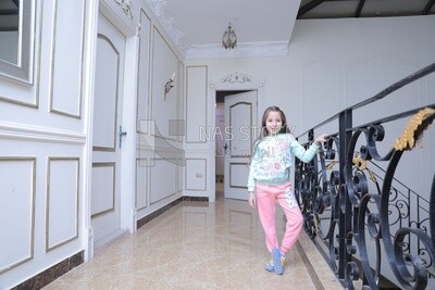 a girl standing in the living room