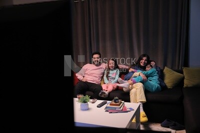 a family of four watching television