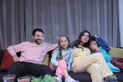 a family of four watching television