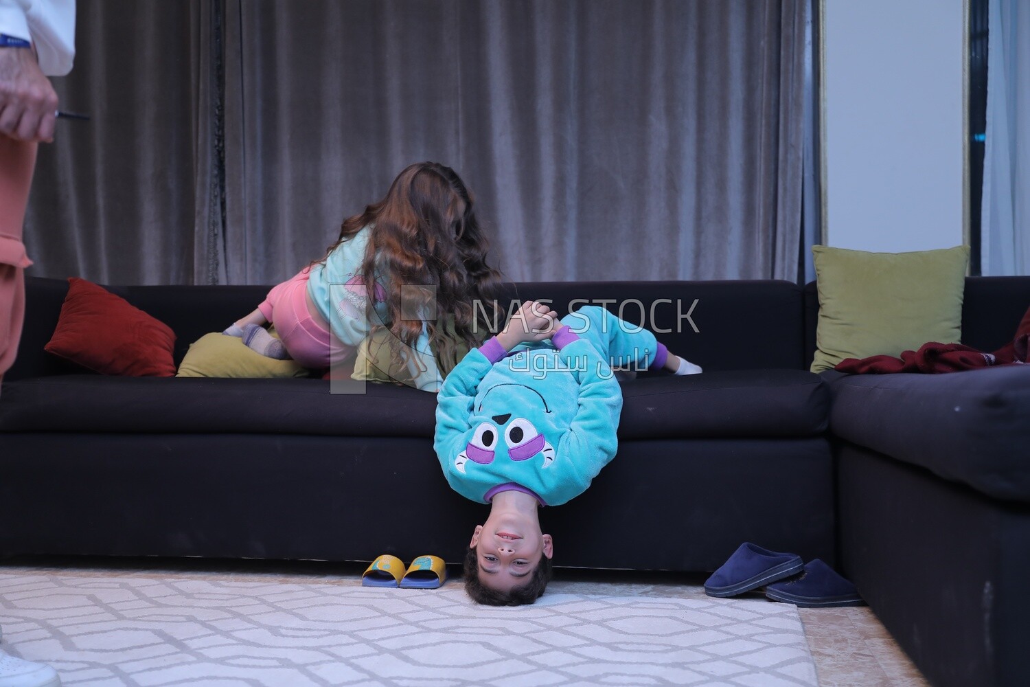 a brother and a sister playing in the living room