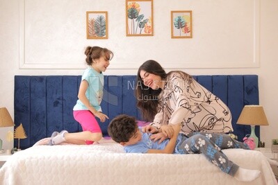 a woman sitting with her children playing