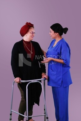 A nurse standing beside an old woman with a walker