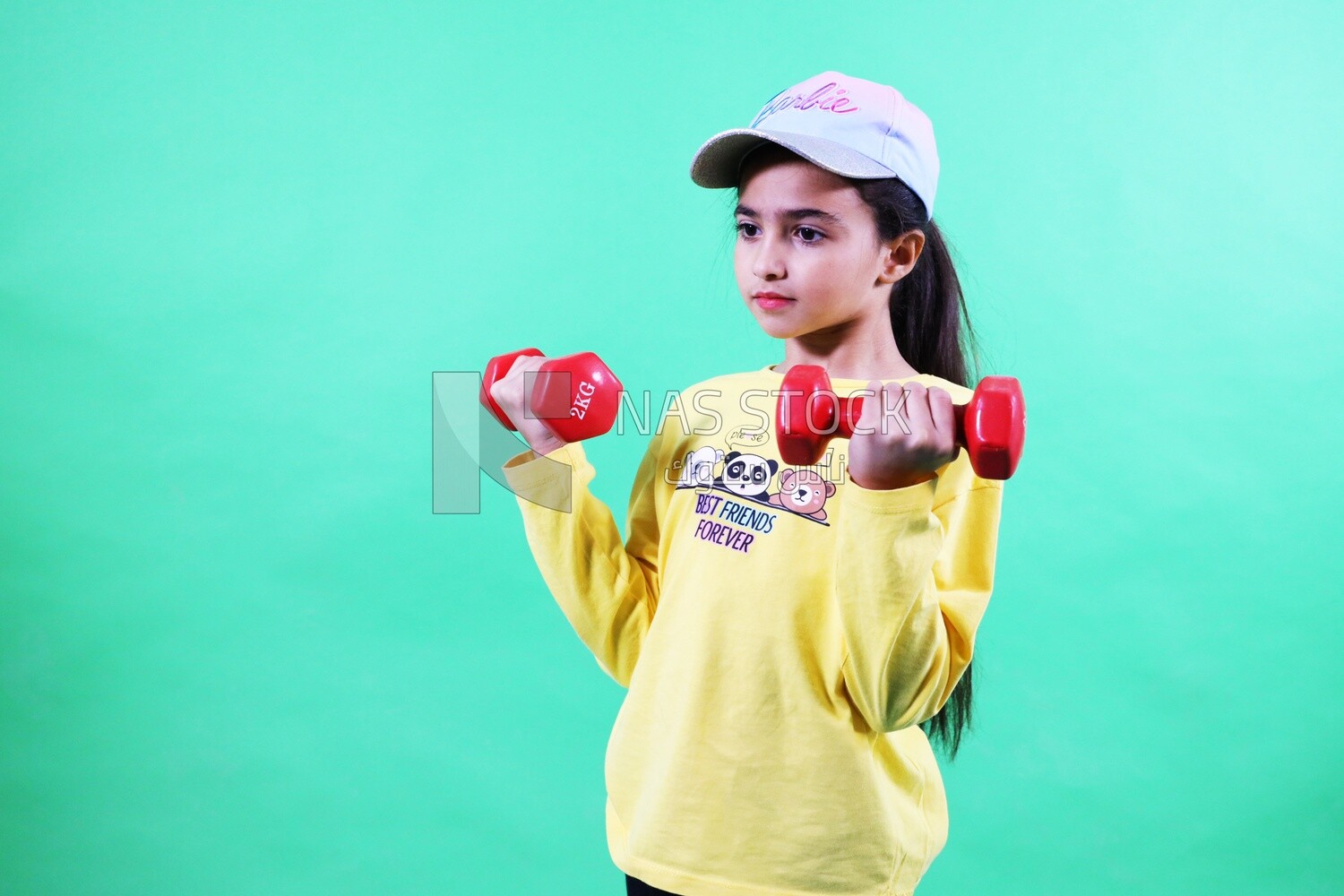 A girl holding dumbbells