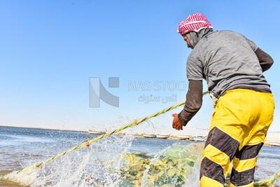 Fisherman collecting fishing nets