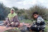 Lady and boy at field