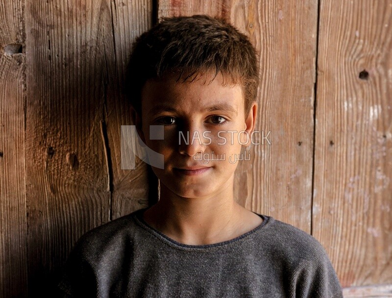 Boy with wooden backgroun