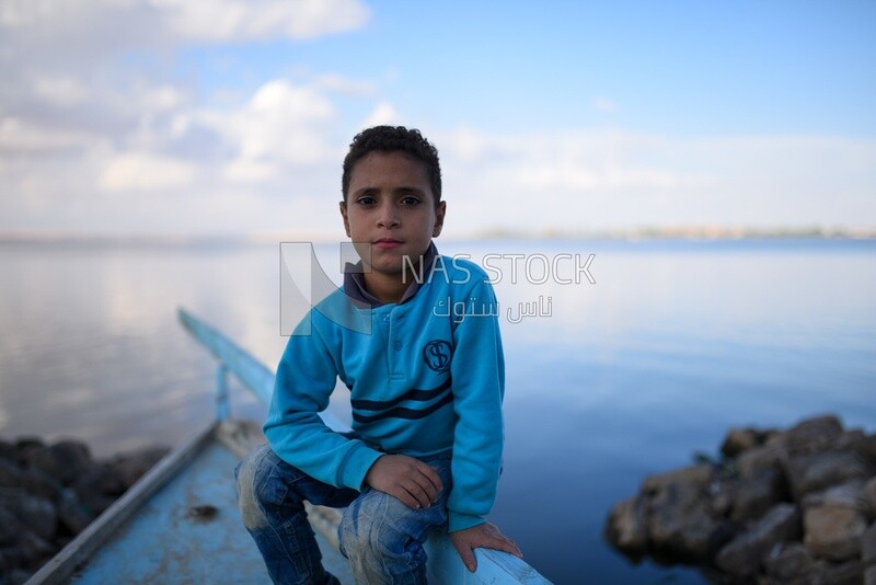 Kid sitting in fishing boat