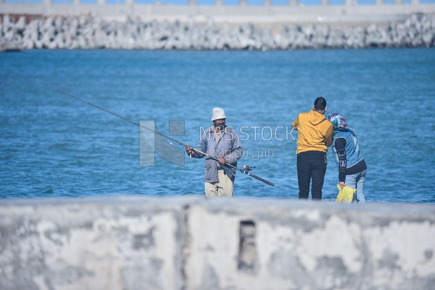 Couple and a fisherman