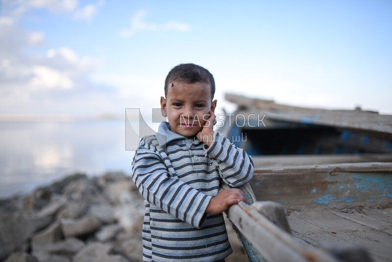 Kid hold fish boat