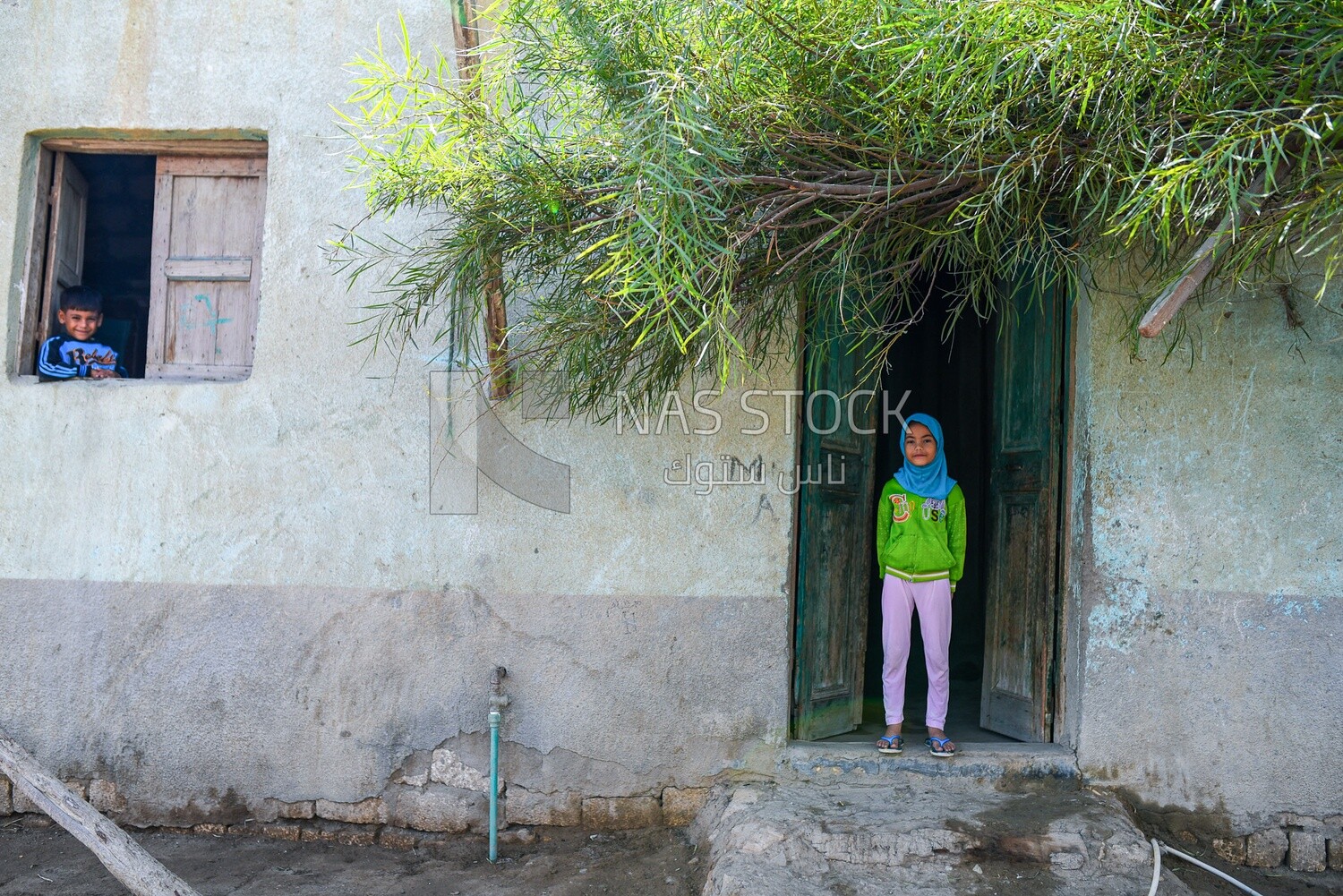 Veiled girl &amp; boy at window