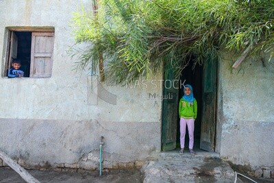 Veiled girl &amp; boy at window