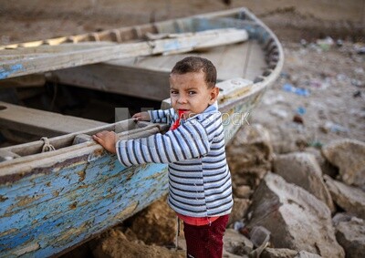 kid hold fish boat