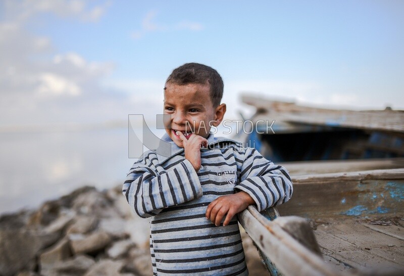 Kid hold fish boat