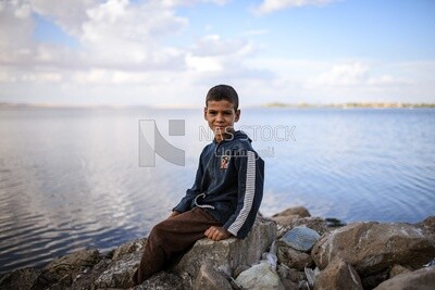 Kid sitting on the rock