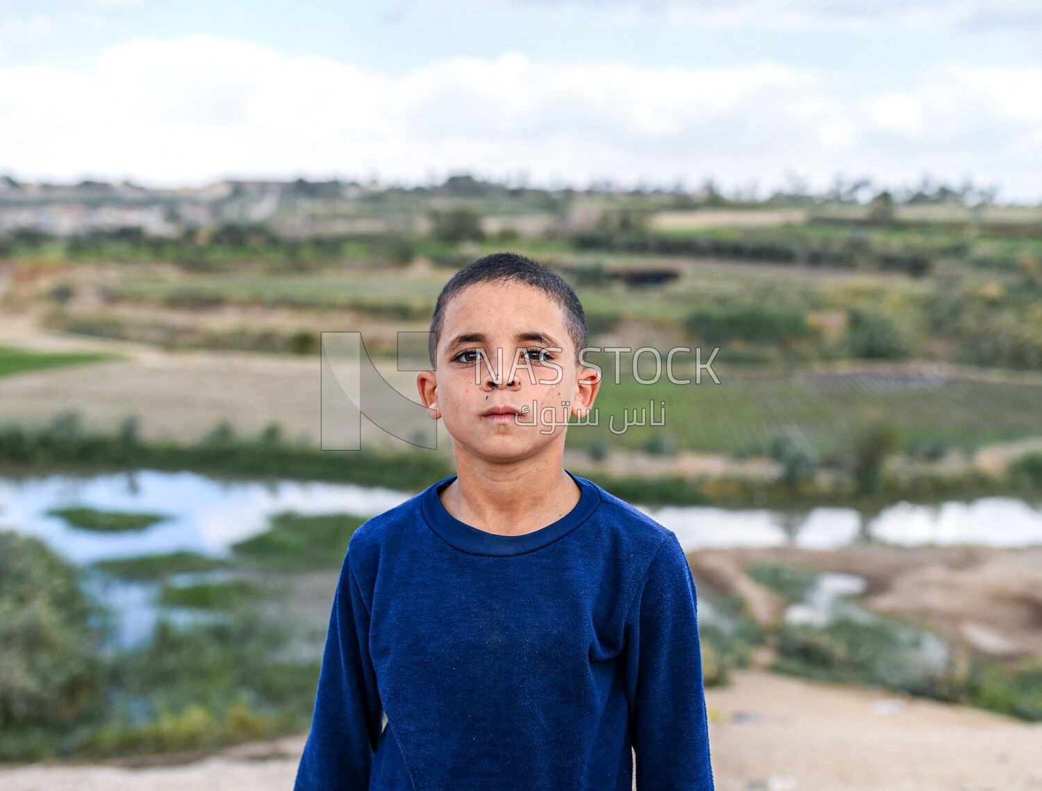 Kid stand at a farm