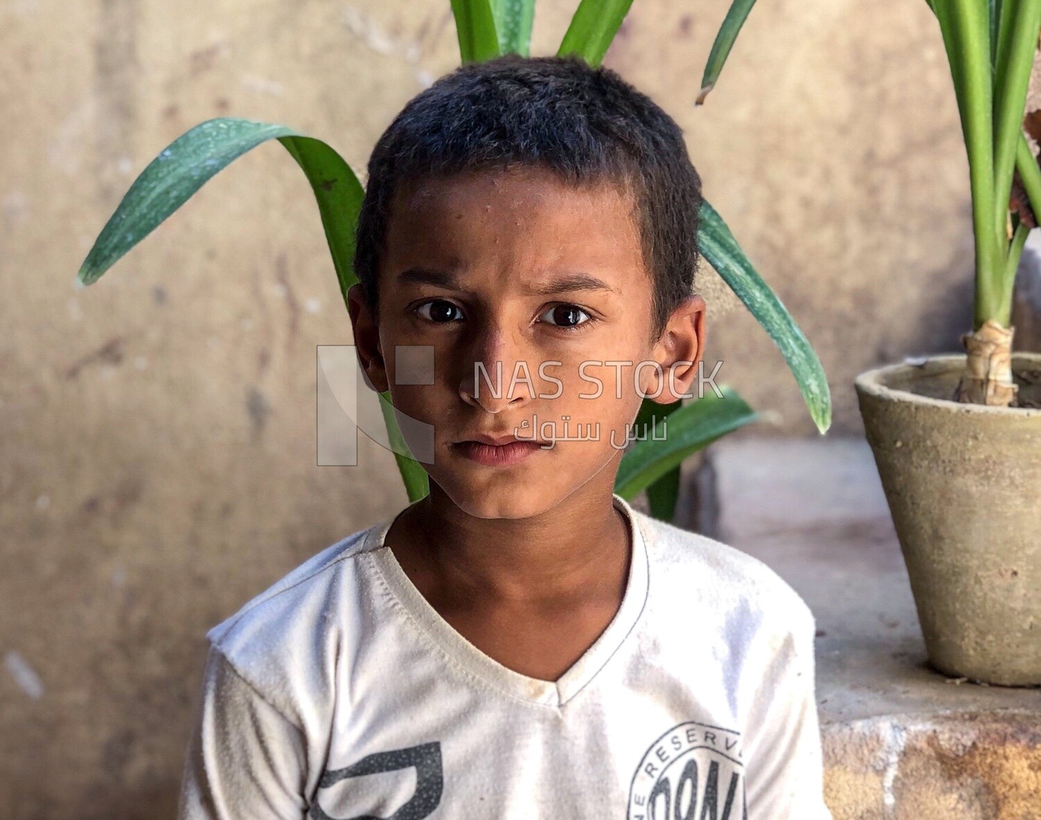 Boy with pots in back ground