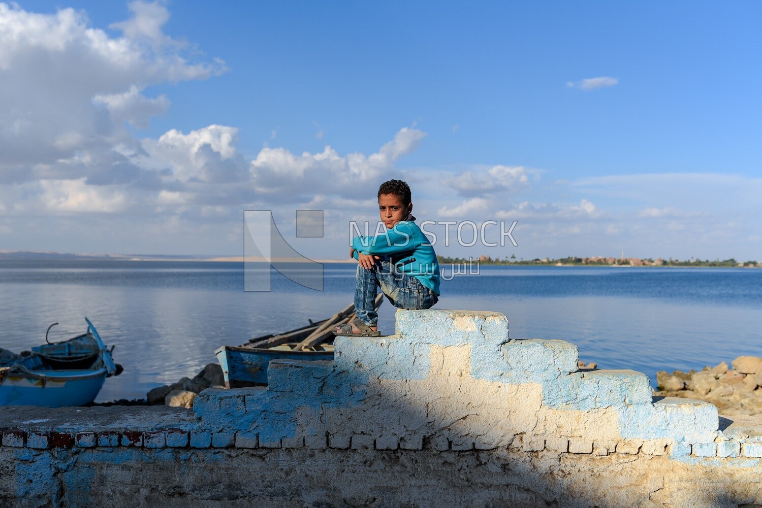 Boy sitting in a lake