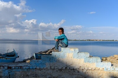 Boy sitting in a lake