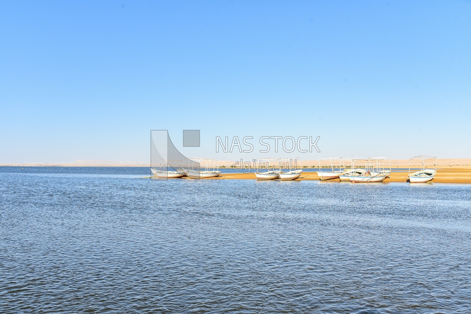 Group of wooden fishing boats on the bank of a lake