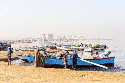 Group of fishermen with wooden boats
