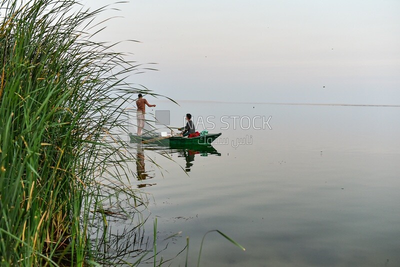 Fisherman with a wooden boat