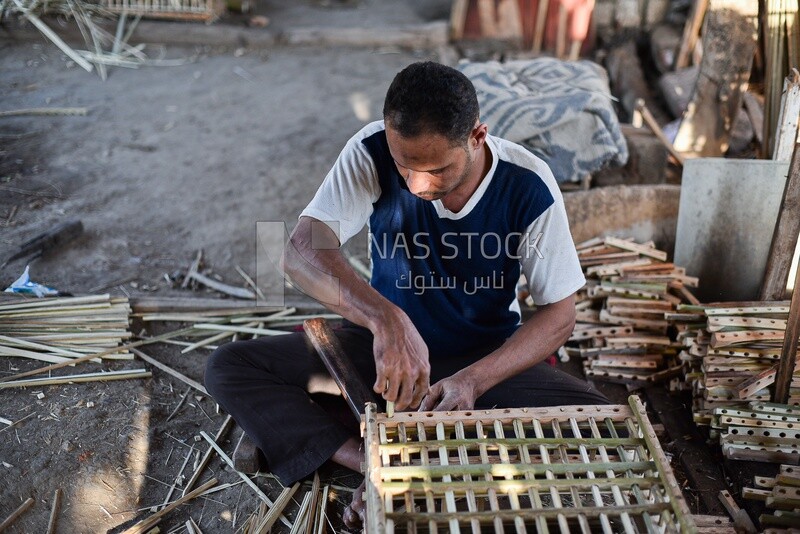 Egyptian craftsman making cages of wicker