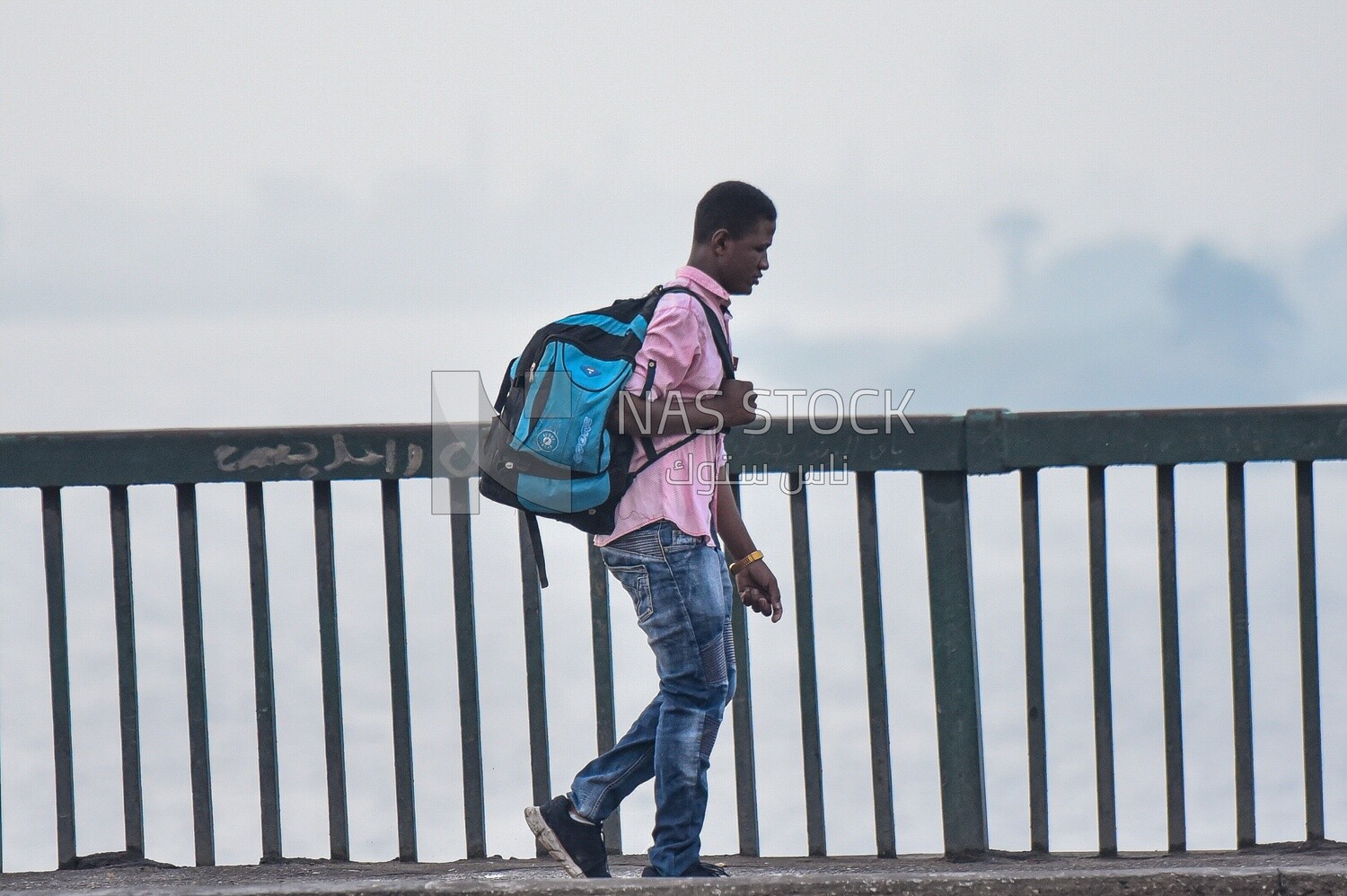 African man walking on Abbas Bridge Corniche