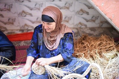 Egyptian woman forming wicker