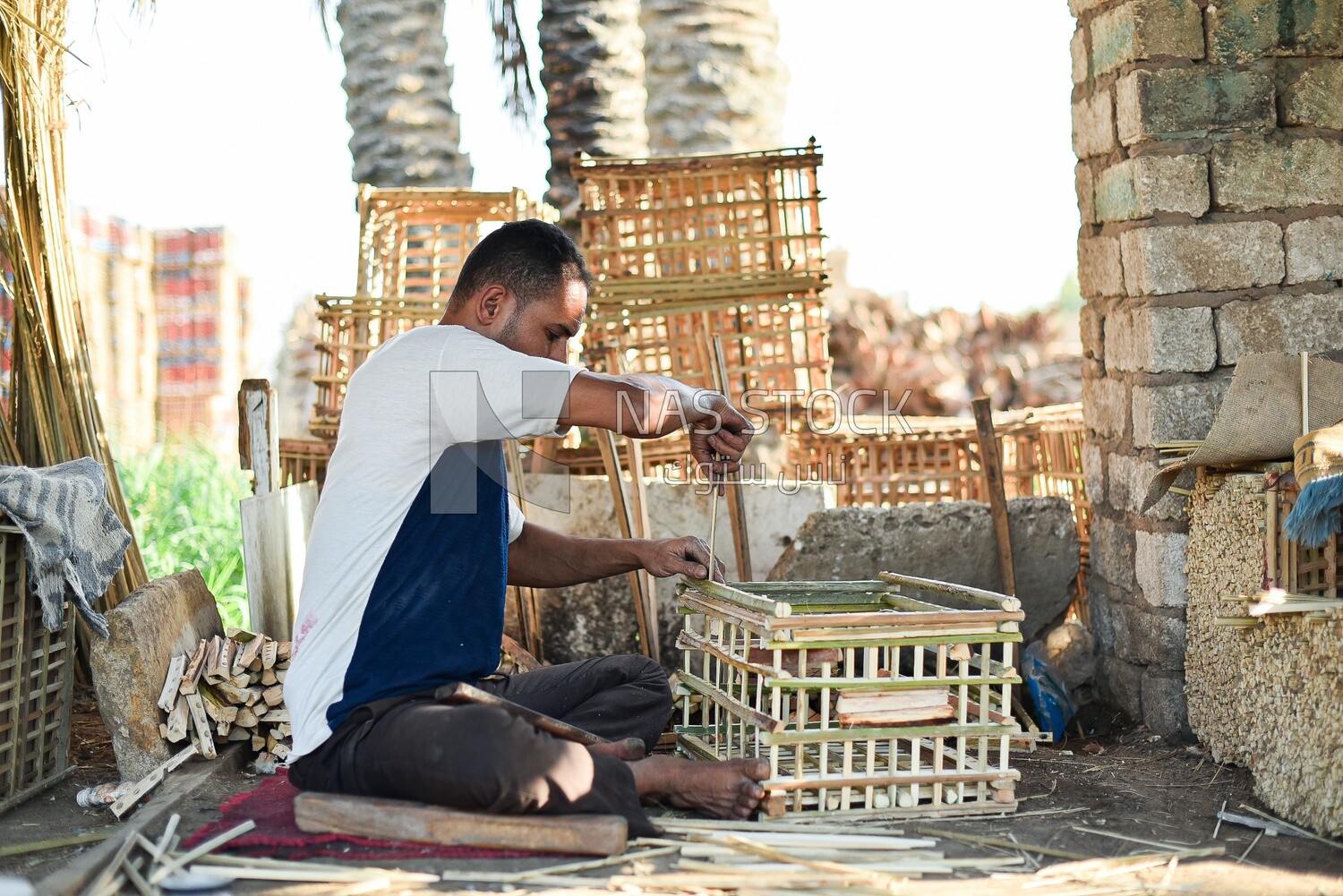 Egyptian craftsman making cages of wicker