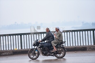 Two men riding a motorcycle