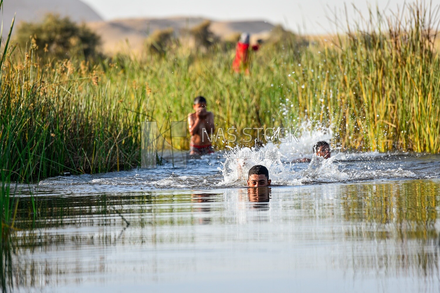 Children swimming in a water channel