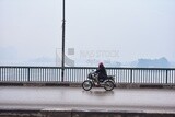 Man wearing a helmet driving a motorcycle