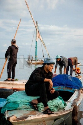 Man sitting on a boat and smiling, fishing, work, summer