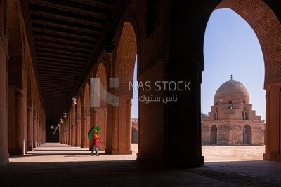Woman with hijab holds an umbrella in the mosque, tourist, mosque